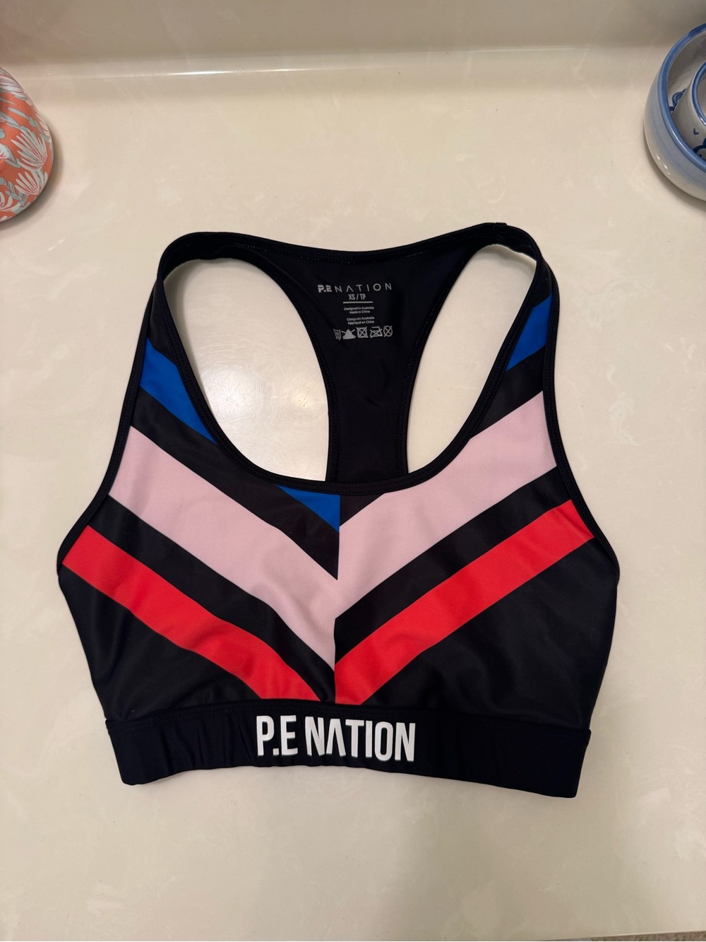 P.E NATION Black Colorblock Racerback Sports Bra with Red, Pink & Blue Accents